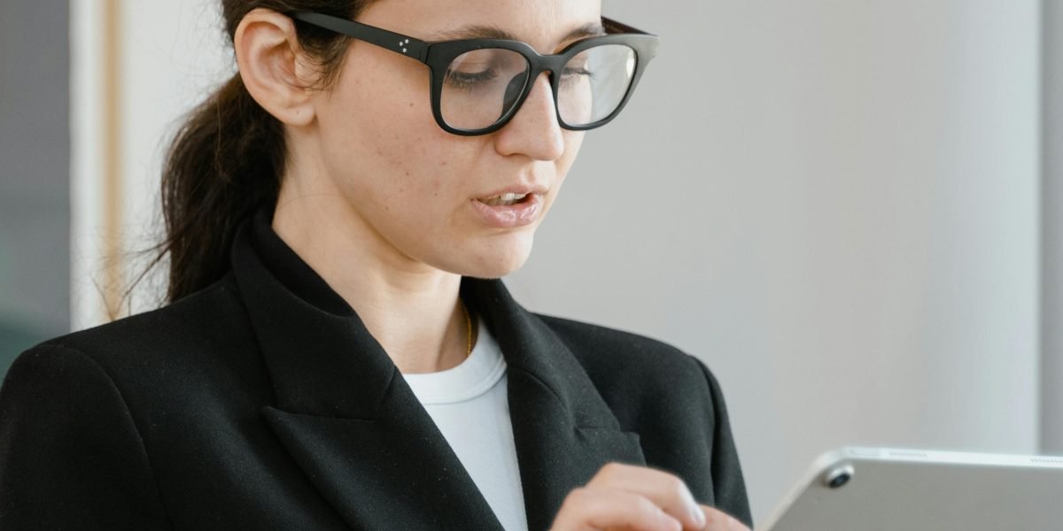 A person deeply focused and engaged with a digital device, symbolizing interaction with personalized and adaptive content.