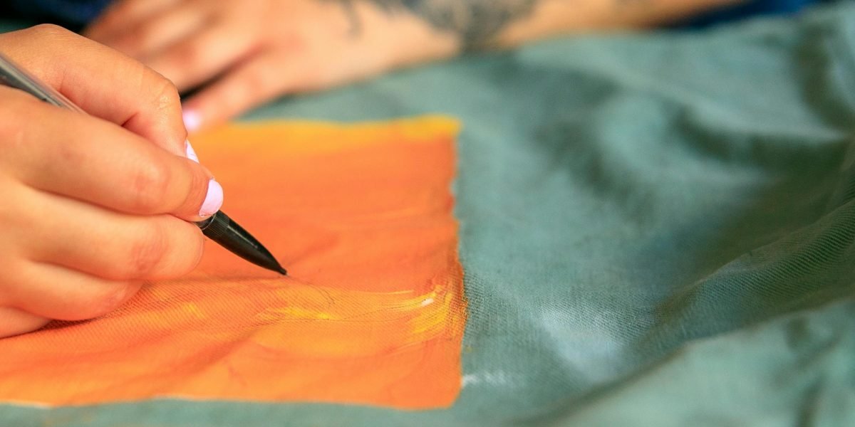 A person carefully choosing elements to personalize an item, reflecting the human desire to make technology feel unique and expressive.
