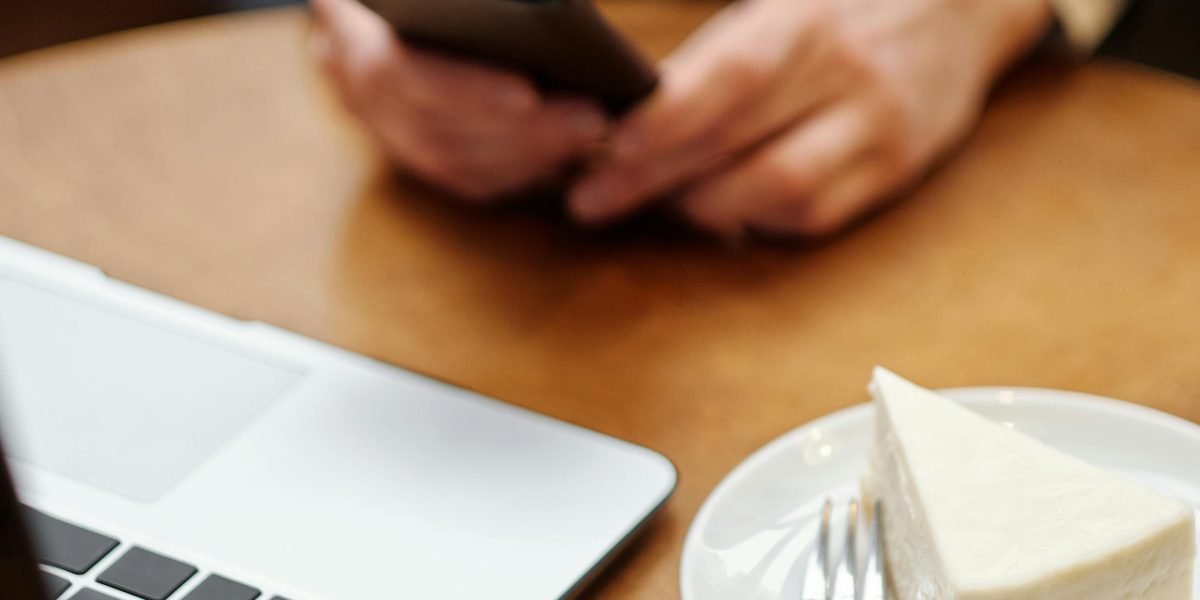 Someone holding a smartphone with a stylish, high-quality leather case in a professional setting.