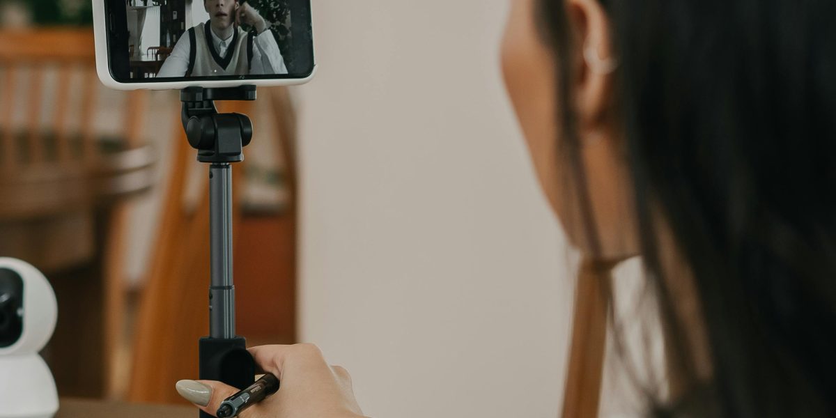 A person comfortably watching a video or reading content on a large-screen smartphone.