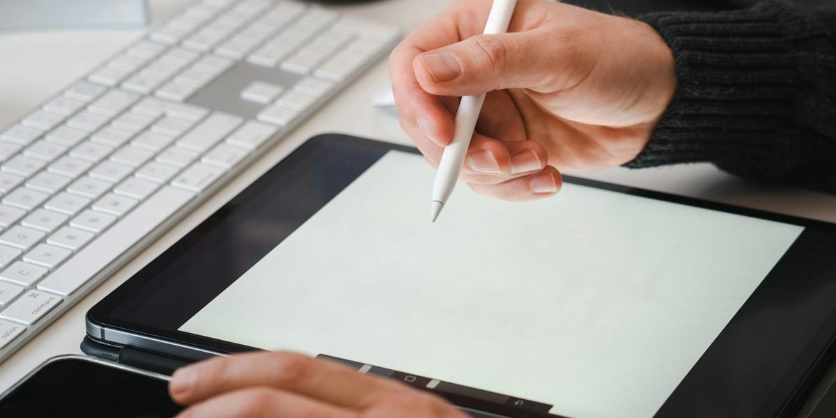 An individual engaging in digital art or design on a screen, showcasing creative expression with a stylus.