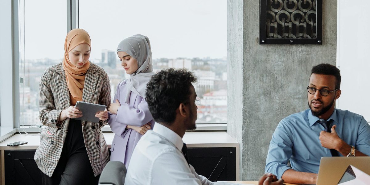 People engaged in a diverse business meeting, demonstrating effective communication with the aid of translation technology.
