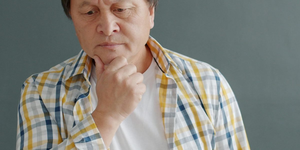 A person contemplating choices, reflecting the challenge of selecting the right smartwatch from many options.