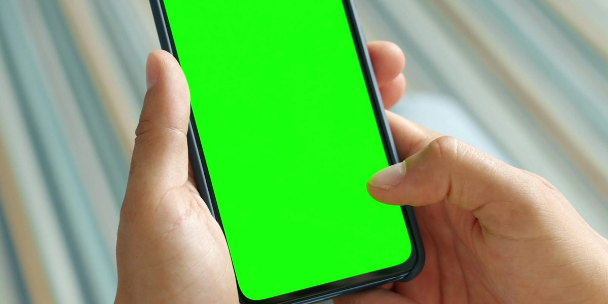 A person holding and admiring the vibrant display and premium feel of a new smartphone.