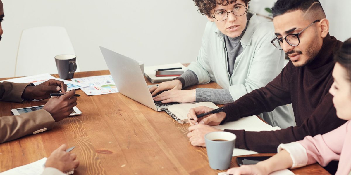A group of scientists or ethicists in a serious discussion, addressing the complex moral implications of advanced technology.