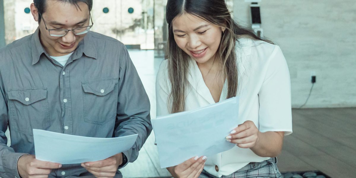 Two professionals reviewing documents, symbolizing the critical lessons learned from a product's lifecycle.