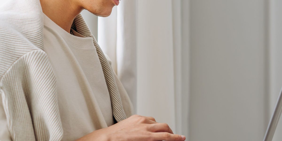 A person thoughtfully examining network devices to troubleshoot a slow internet connection.