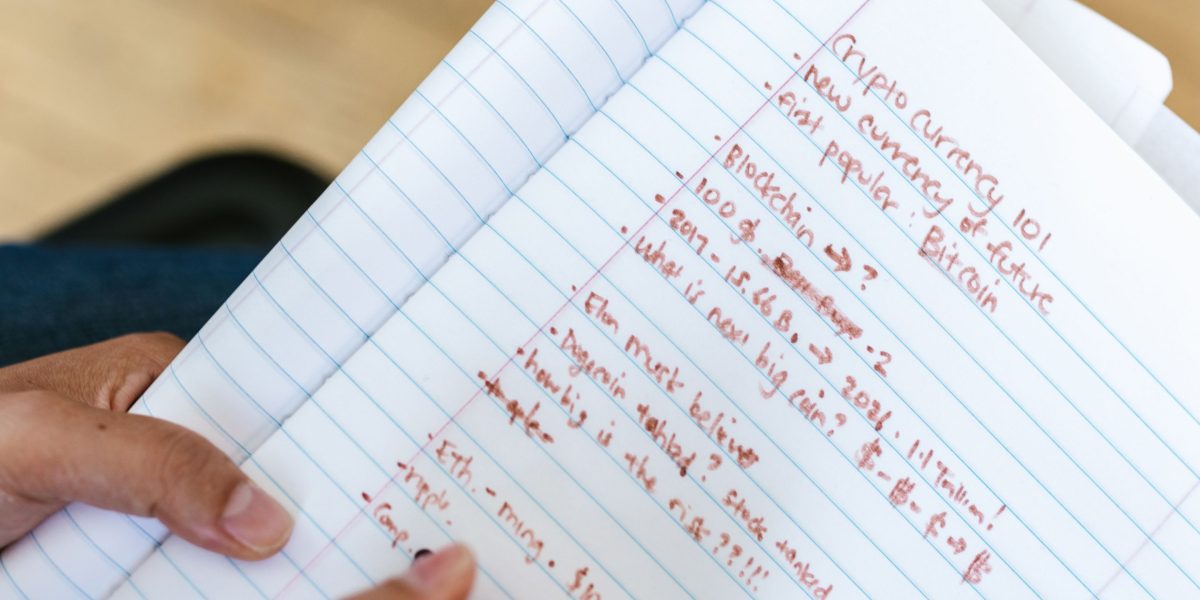 Someone intently reviewing notes or a calendar, strategizing the optimal time to make a financially sound decision.