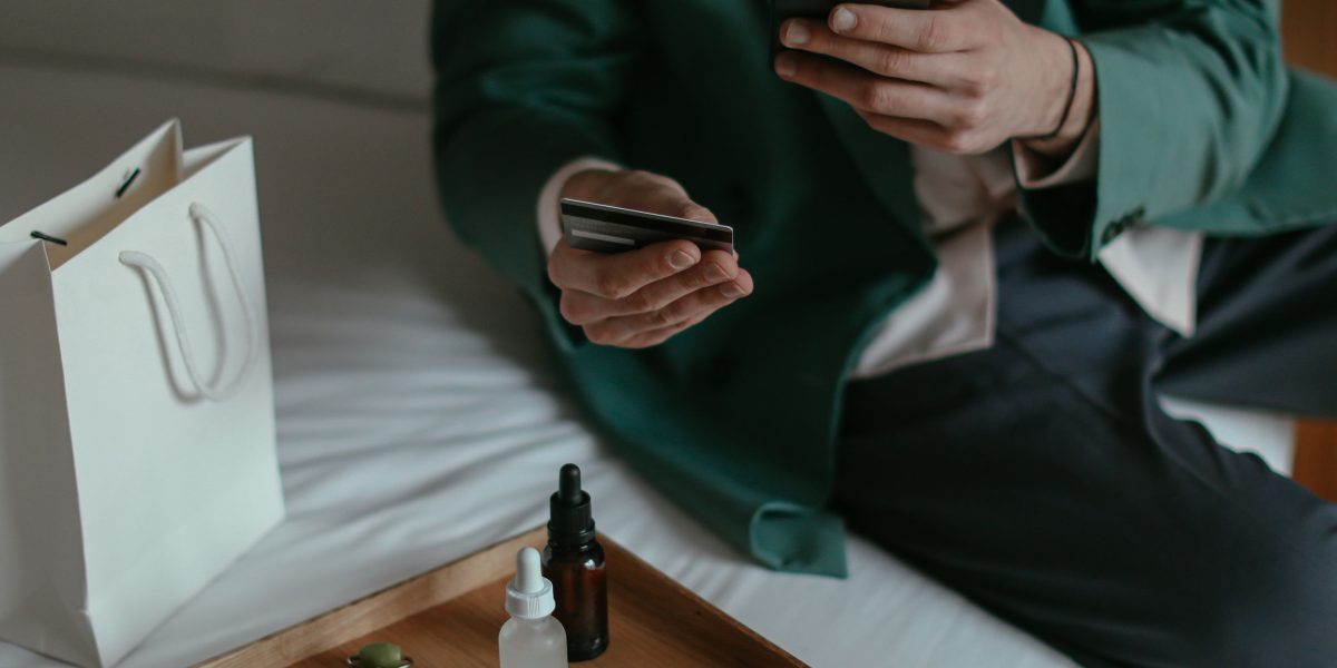 A person contemplates their smartphone options, weighing different models and prices amidst a dynamic tech market.