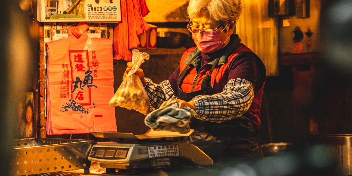 An individual thoughtfully considers different financial choices related to purchasing a new smartphone.