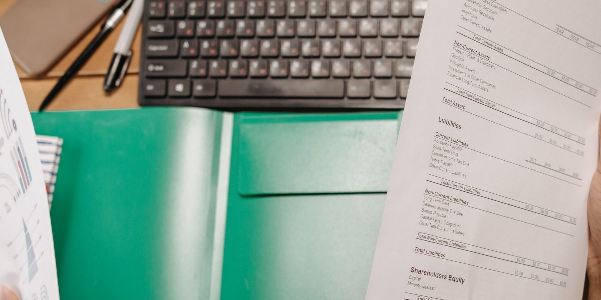 A person carefully reviewing financial documents to make an informed decision on a major purchase.