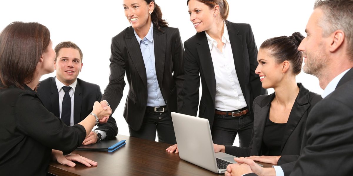 A team of professionals collaborating and analyzing user data on a large screen or whiteboard.