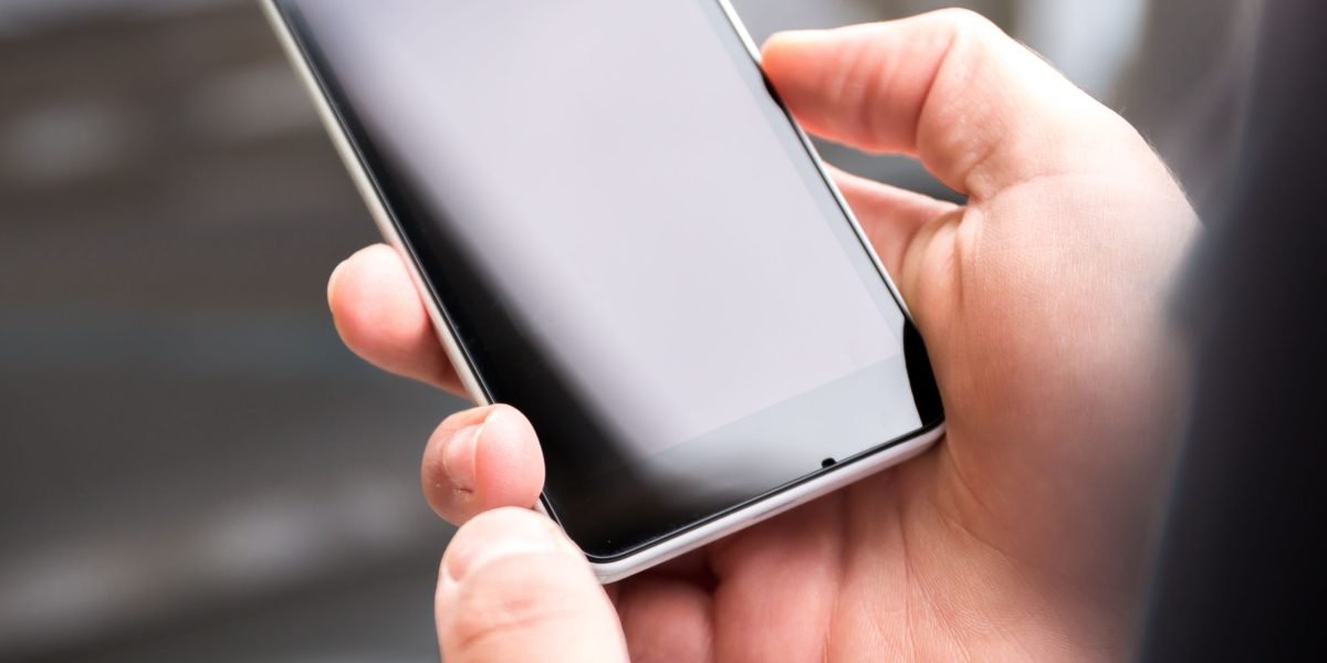 A person carefully navigates through their phone's settings, making informed decisions about app permissions and privacy controls.