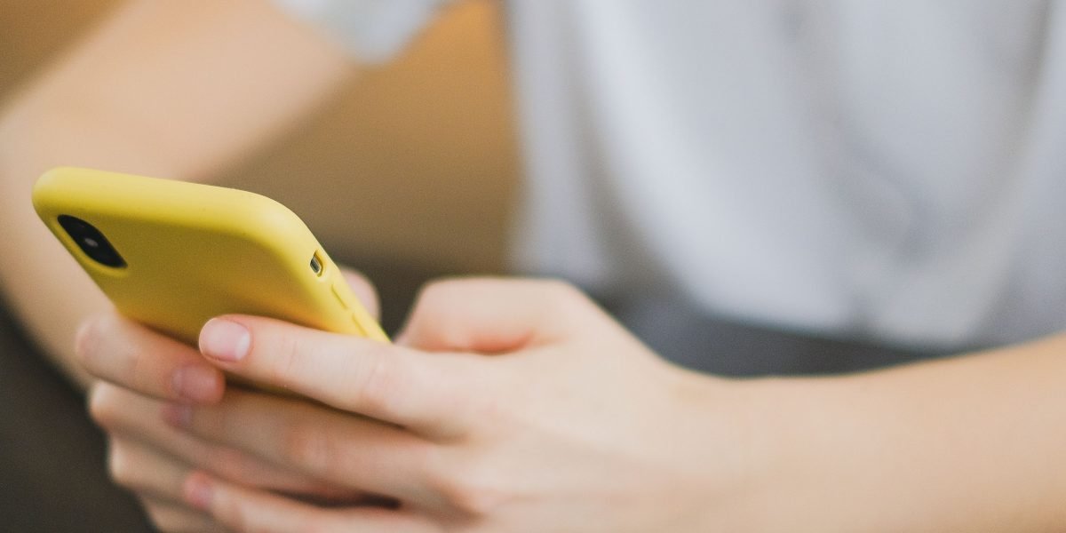 A person confidently using their smartphone, integrating technology into their everyday routine.