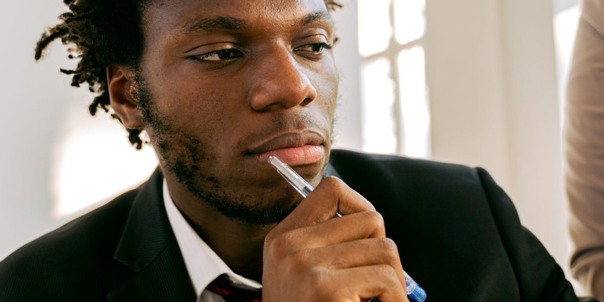 A person deep in thought, considering different options and their implications, representing the decision-making process for advanced phone modifications.