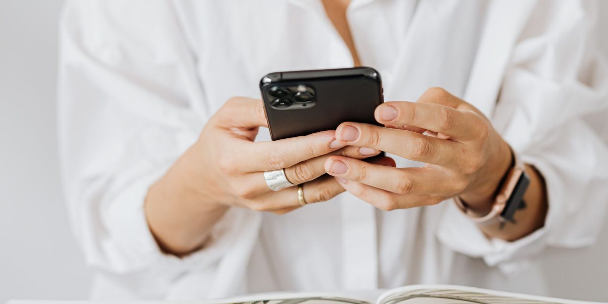 A user carefully examining the design and build quality of a new smartphone.