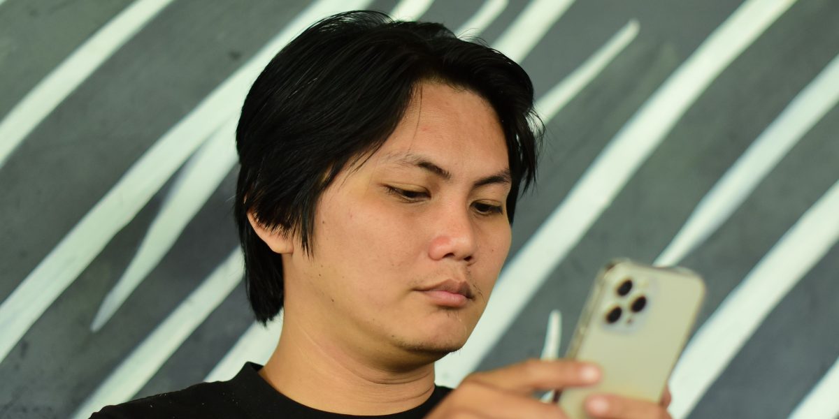 A user interacting with their phone, benefiting from integrated AI features and smart assistance.