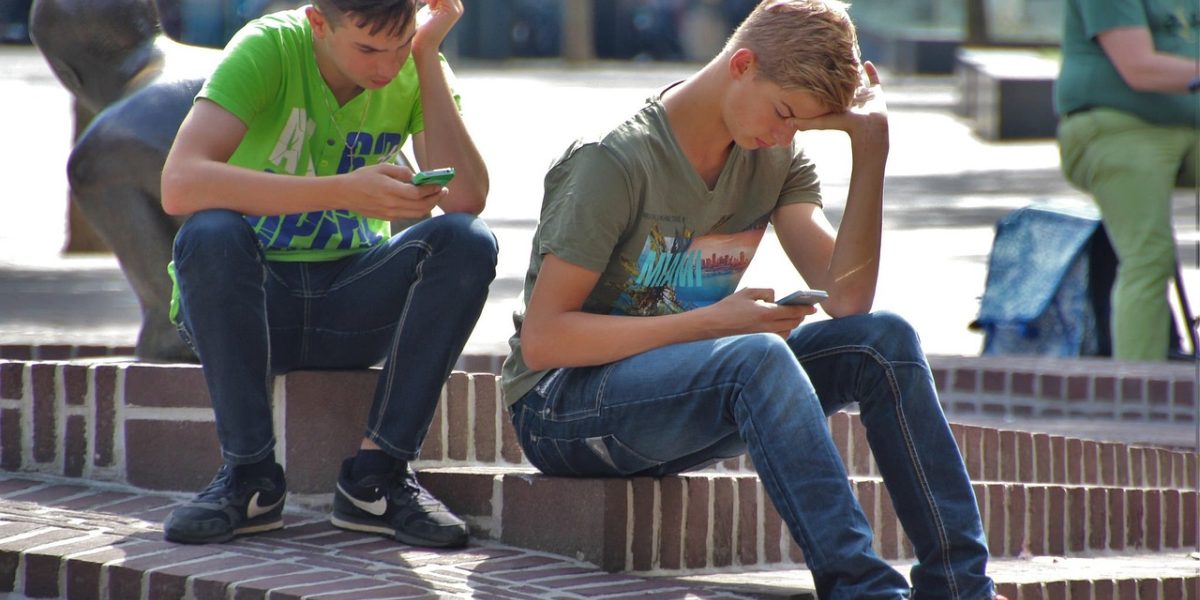 Friends enjoying a shared moment while connecting over a multiplayer mobile game, highlighting the social aspect.