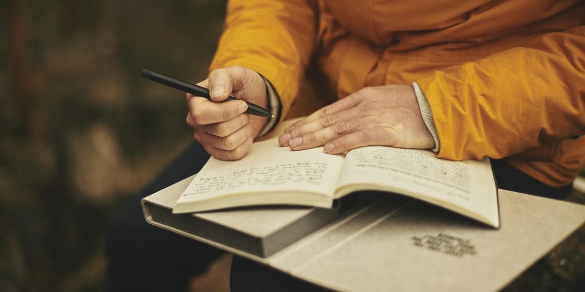 A person carefully reading the terms and conditions of a phone purchase agreement or carrier contract.