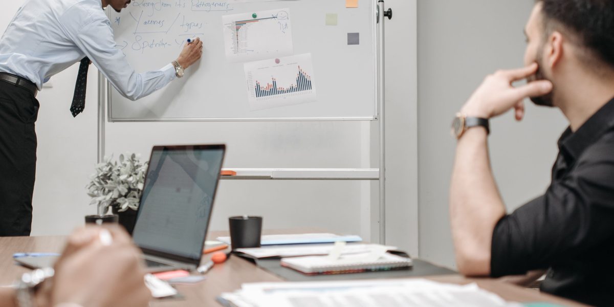 A team of professionals collaborates on strategy, representing the 'big picture' considerations for marketplace legitimacy from a business perspective.