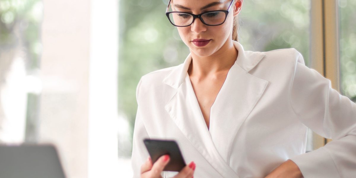 A person confidently interacting with their smartphone, suggesting active management of device settings.