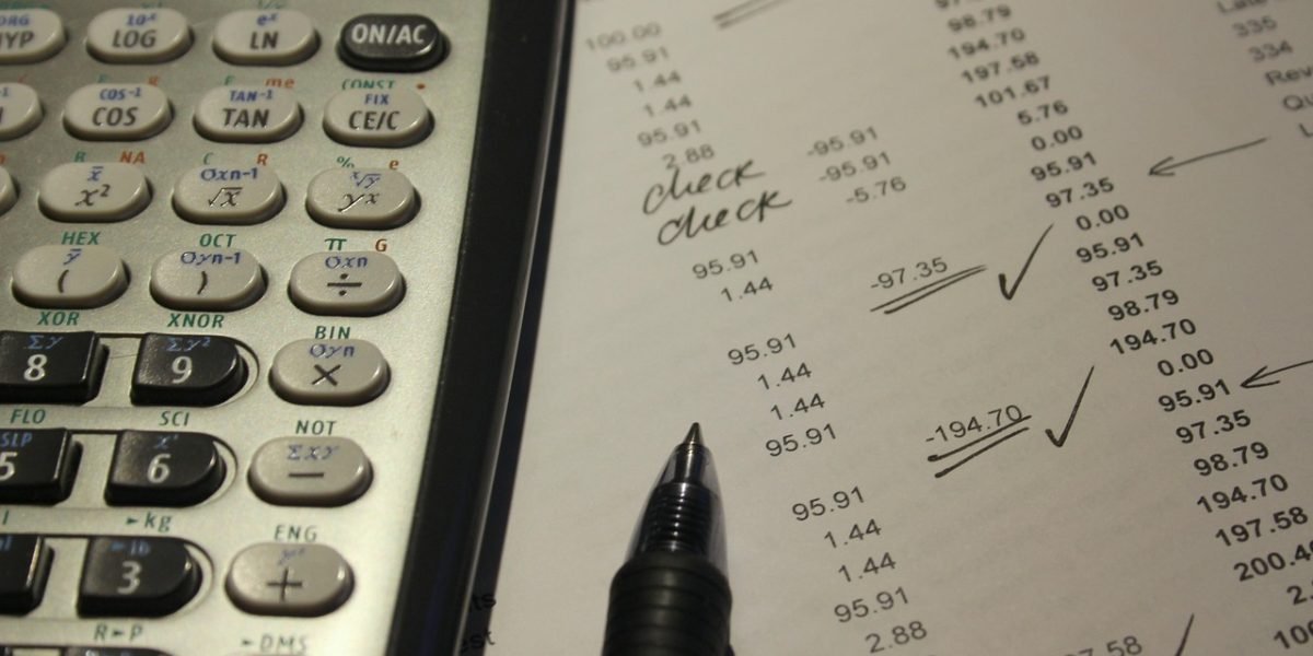 An individual focused on reviewing financial documents, symbolizing the need for factual accuracy in wealth assessment.