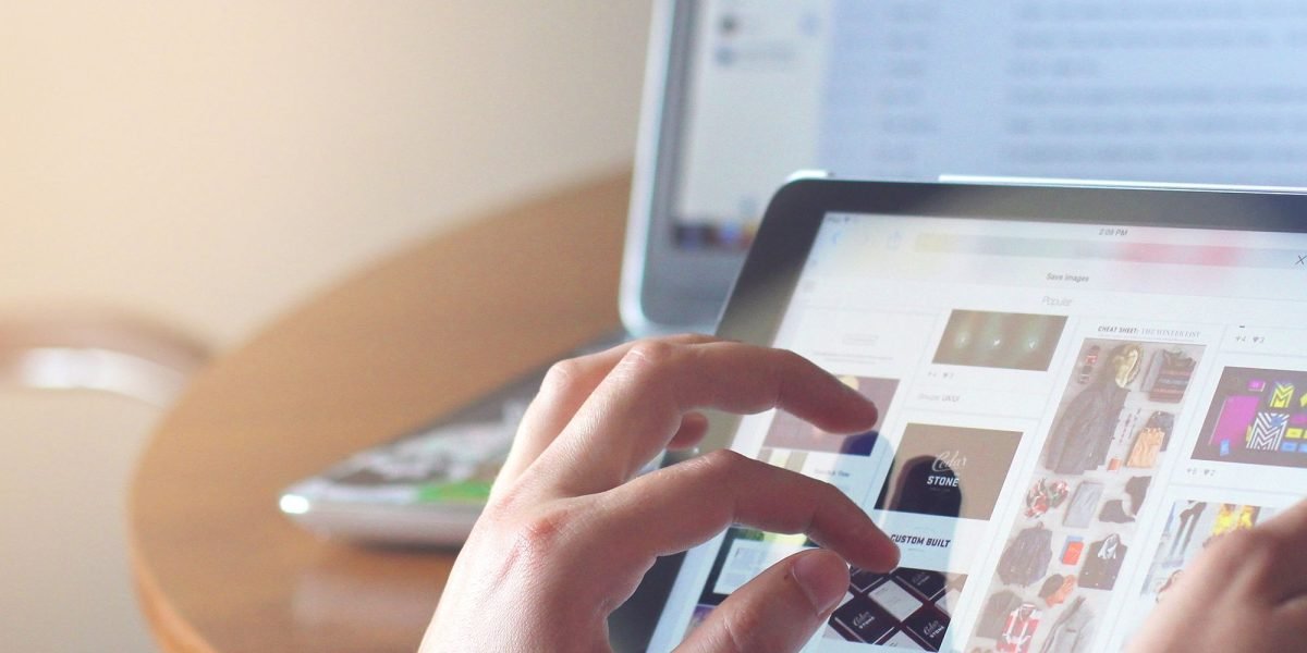 A person smoothly transitions tasks between a tablet, phone, and laptop, illustrating the concept of a connected tech ecosystem.