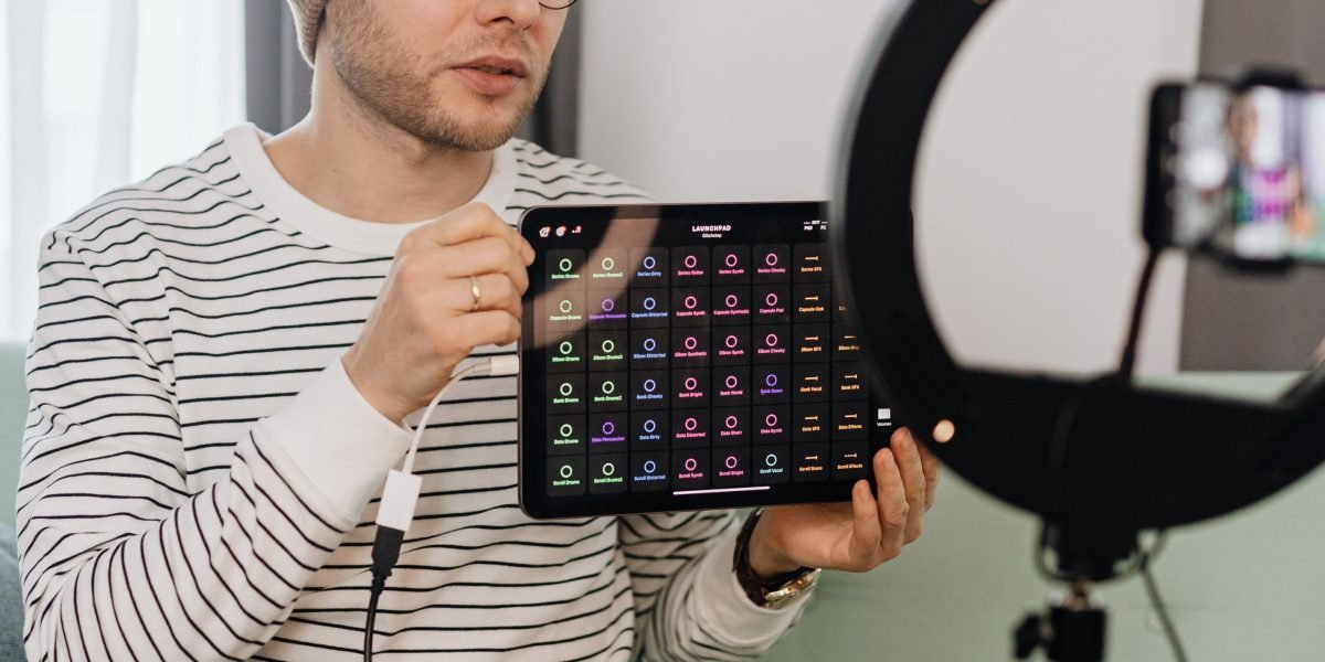 A person reviewing a tablet and various accessories, considering the full cost of ownership beyond the initial purchase price.