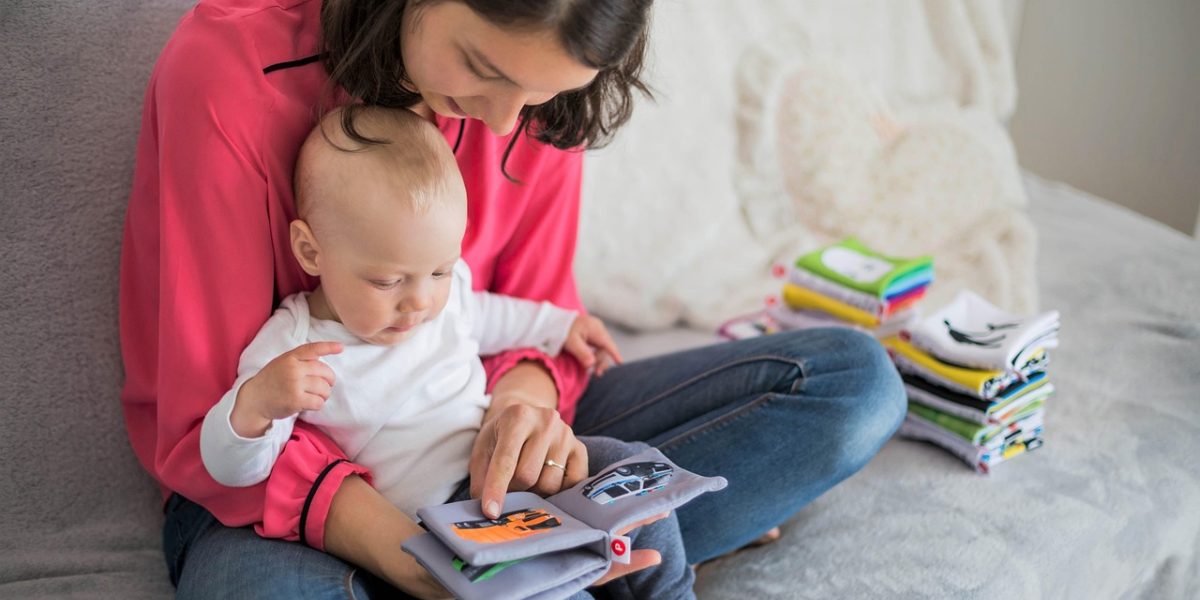 A parent and child engaged in a shared reading activity, emphasizing interaction.