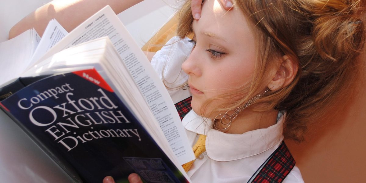 An adult learner engaged in language acquisition, possibly using a game or app.