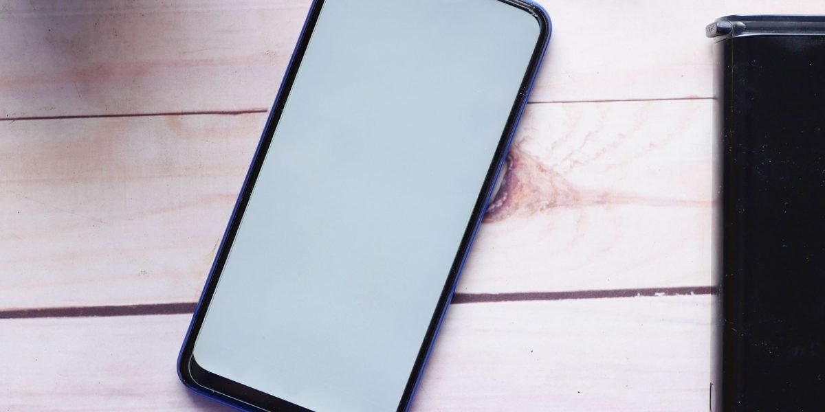 A person checking their smartphone's battery life, a common concern for users of older devices.