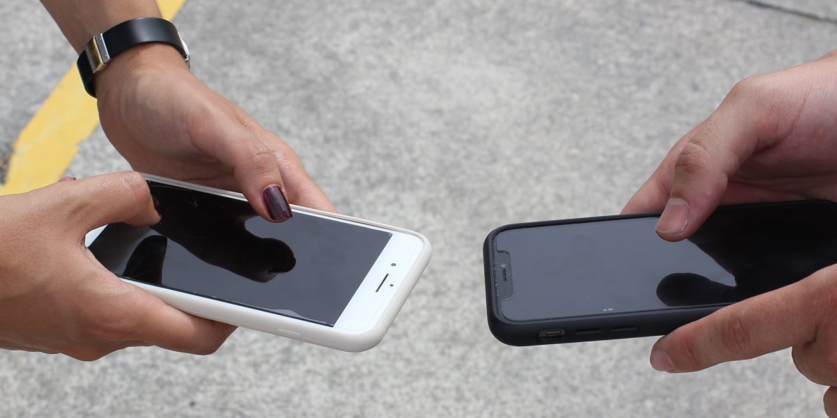 A person thoughtfully examining different iPhone 14 Pro Max cases to find the perfect blend of style and protection.