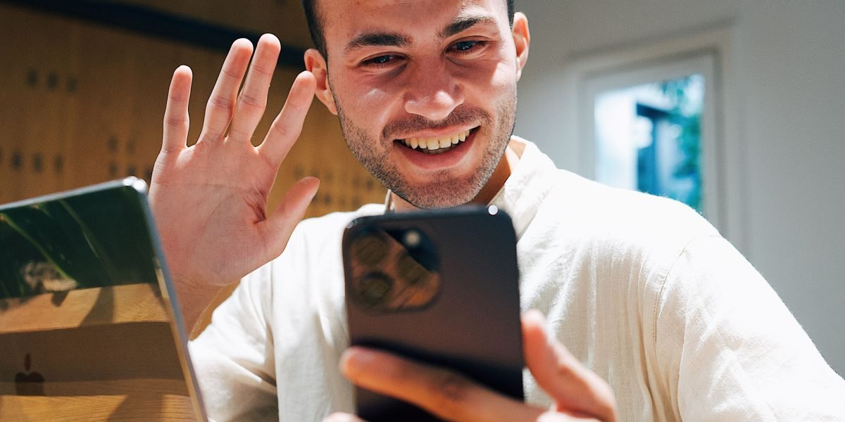 A person preparing their phone for a video call, utilizing a case with a built-in kickstand for hands-free convenience.