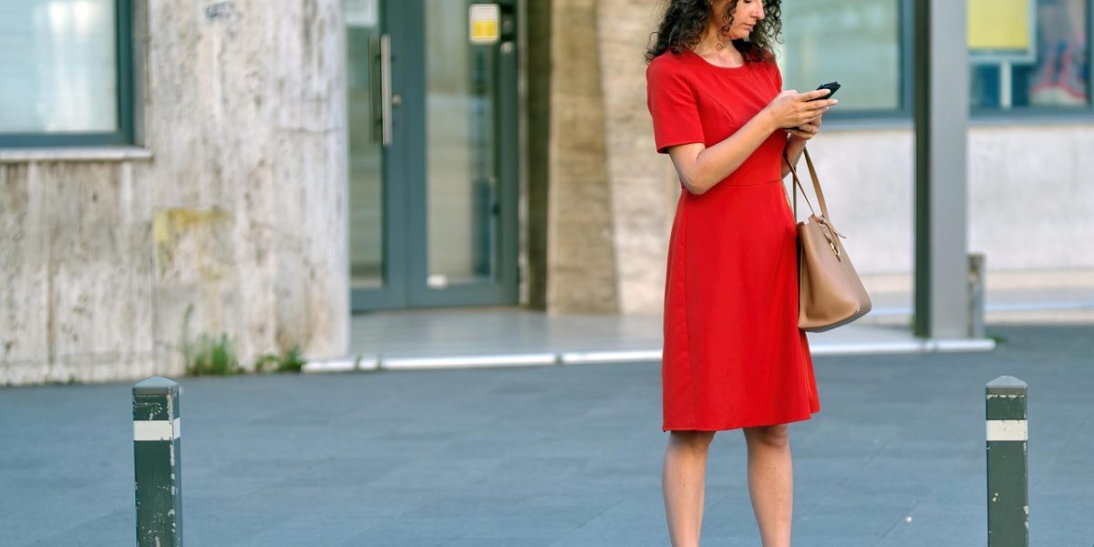 A person happily unboxing or admiring their new iPhone, anticipating its use and protection.