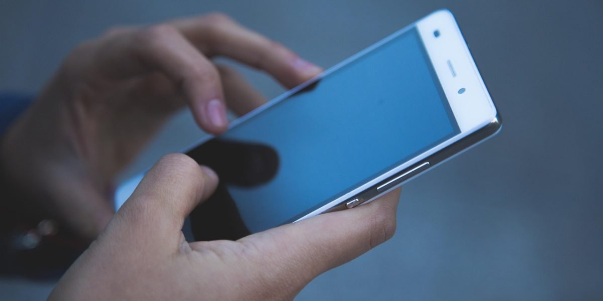 A person holding their phone with confidence, assured by its strong protective case.