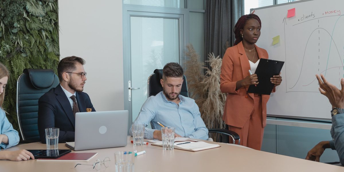 Business professionals collaborating in a meeting, making strategic decisions about technology adoption and infrastructure.