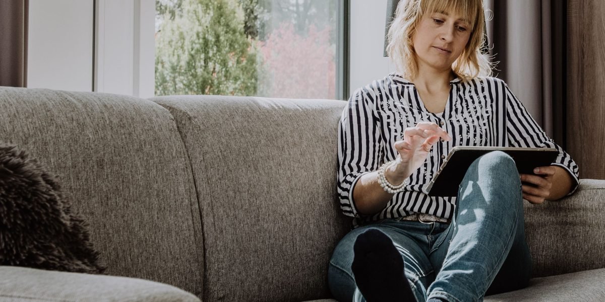A person comfortably interacting with smart home devices, showcasing the seamless integration of IT into daily life.