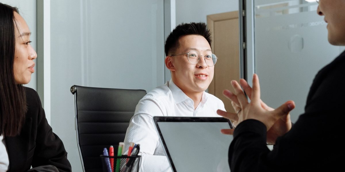 A professional discussing or reviewing documents in an office, illustrating compliance with workplace policies and ethical conduct.