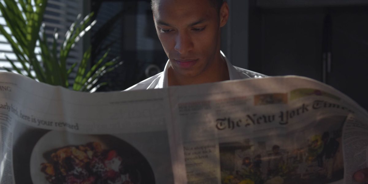 A person reads and processes complex information to distinguish signal from noise.