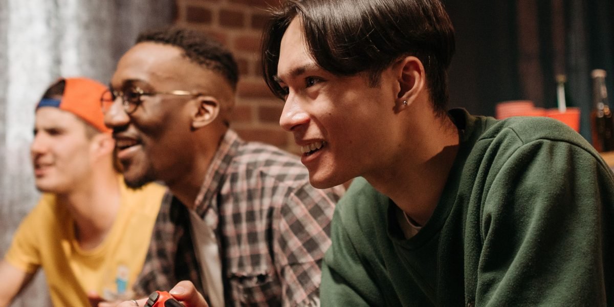 A group of friends laughing and enjoying a game together, symbolizing strong player communities and engagement dynamics.