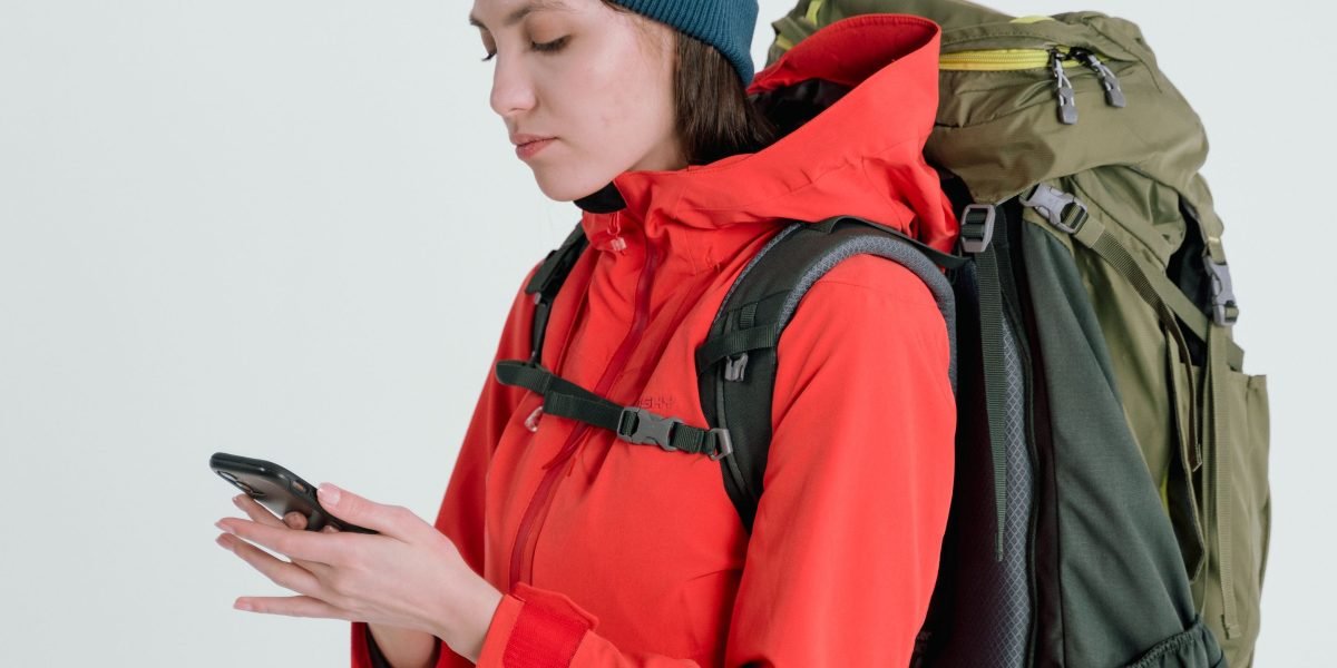 A person confidently planning international travel, contemplating phone flexibility for local SIM cards.