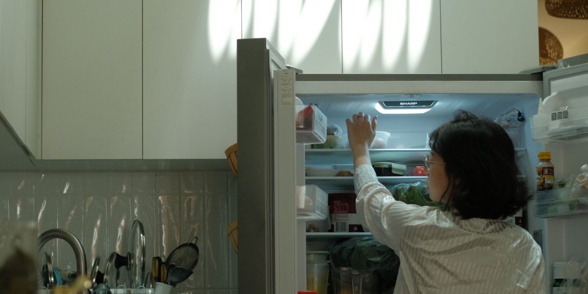 A person actively searching for lost keys or personal items in their home.