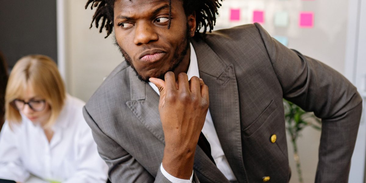 A person thoughtfully considering their options for a new phone, reflecting on smart choices for technology purchases.