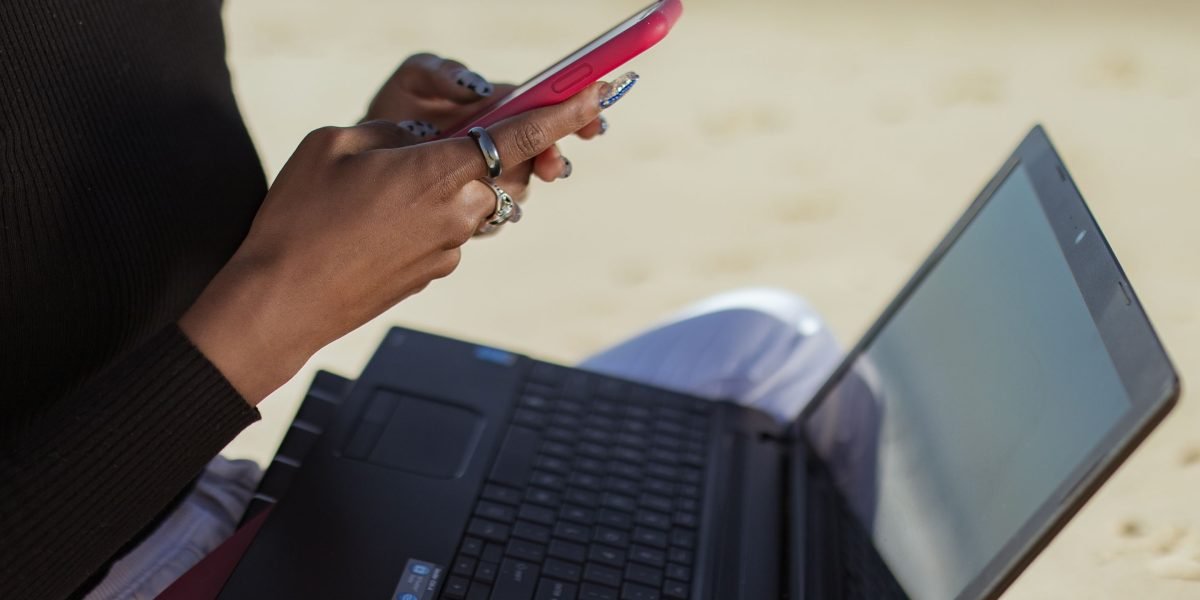 A person working happily outdoors, symbolizing the expansion of global internet access to previously unconnected regions.
