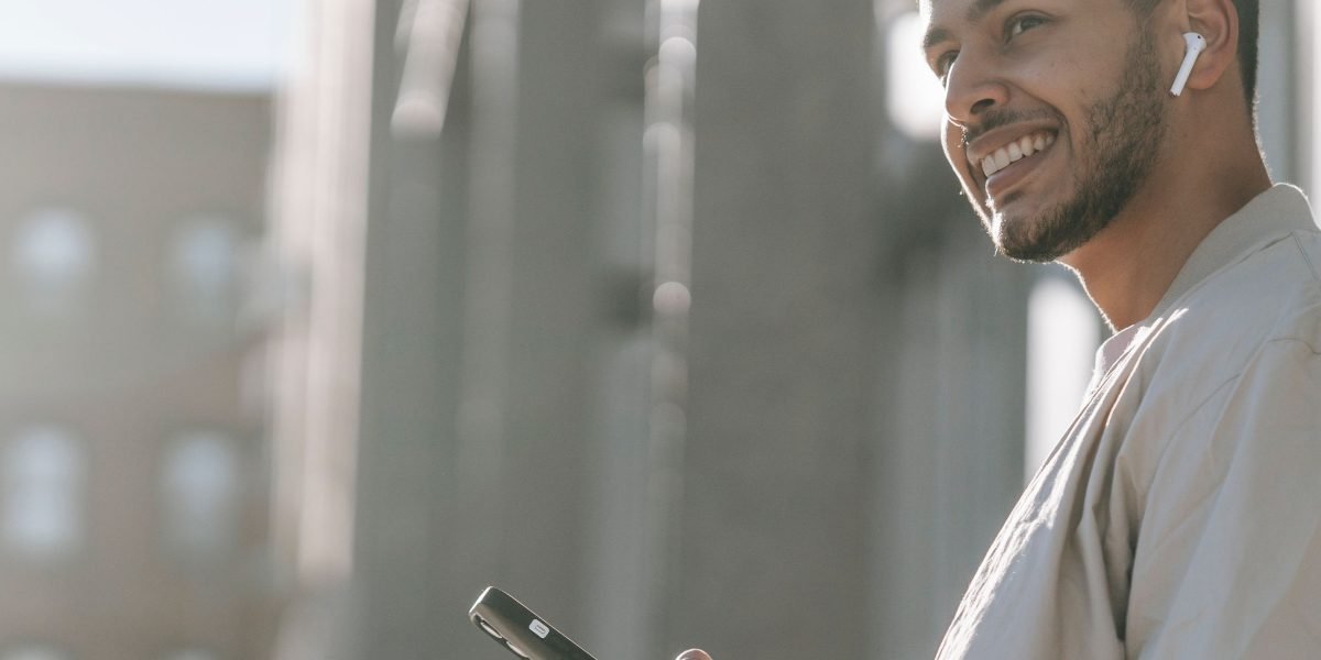 An individual using their phone in an active outdoor setting, highlighting the durability needed for busy lives.